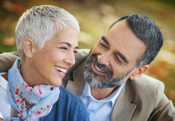 istock Mature couple relaxing in the park. 1387218393