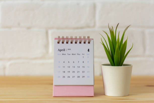 istock Desktop calendar for April 2022 for planning on the table. 1387218676
