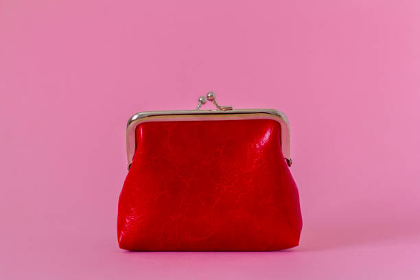 istock An open red coin purse on a pink background with a copy space. 1387218718