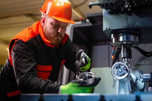 istock Mechanical technician operative of cnc milling cutting machine center at tool workshop 1387218979
