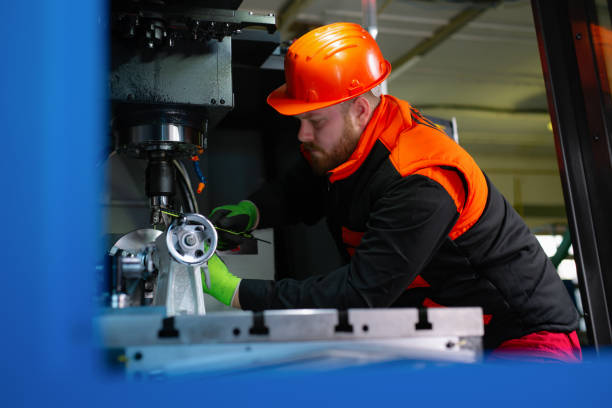 istock Mechanical technician operative of cnc milling cutting machine center at tool workshop 1387218997