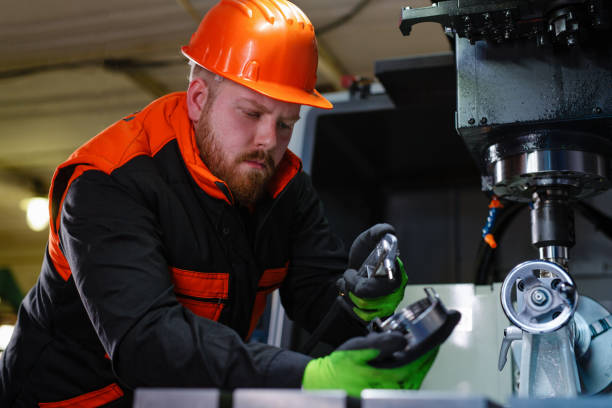 istock Mechanical technician operative of cnc milling cutting machine center at tool workshop 1387219782