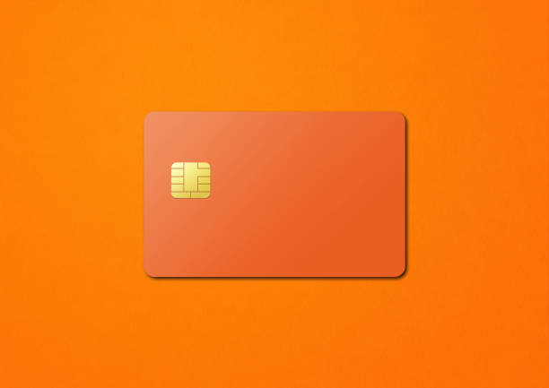 istock Orange credit card on a color background 1387219795