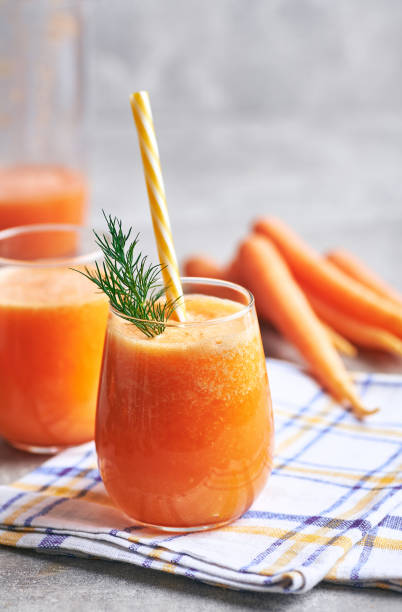 carrot juice served in glass. - dieting front view vertical lifestyles imagens e fotografias de stock