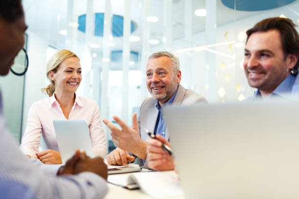 istock Happy human resource team having a job interview with a candidate in the office. 1387220085