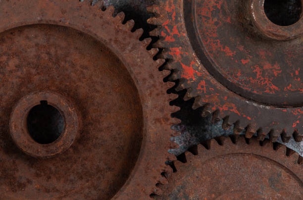 istock Old rusty metal gears on a rusty textural background 1387221045