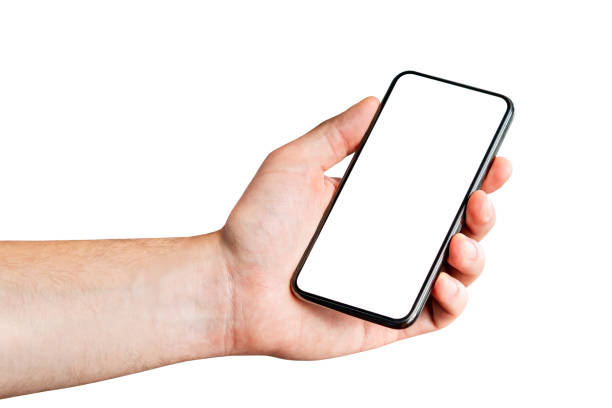 Phone in hand, white background. Man holding isolated cellphone. Blank screen for mockup or application. Empty display for app design. Telephone cutout. Digital template. stock photo