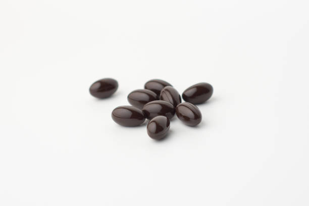 istock group of black soft gel capsules on a white background 1387222072