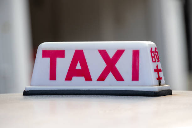 girl in taxi and man on street giving the fingers each other