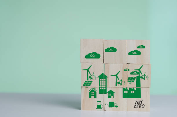 Wooden cubes with net zero and carbon neutral green factory icon symbol background and copy space. stock photo