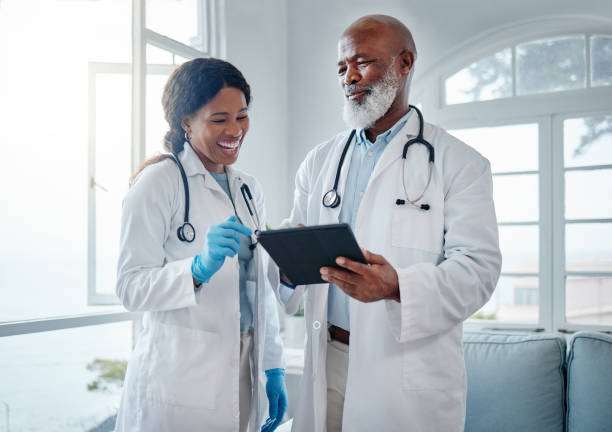 istock Shot of two doctors using a digital tablet together in a medical office 1387225111