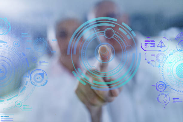 Close up of unrecognizable chemist touching transparent screen while working on futuristic development in laboratory.