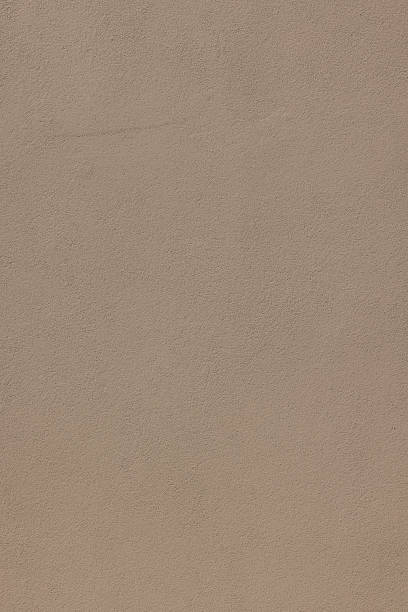 istock Part of a new light brown concrete wall 1387226144