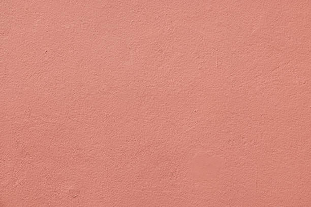 istock Part of a clean peach colored concrete wall 1387227266