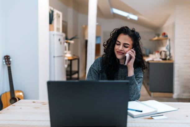 istock Young woman with computer and smartphone indoors, working inhome office. 1387235793
