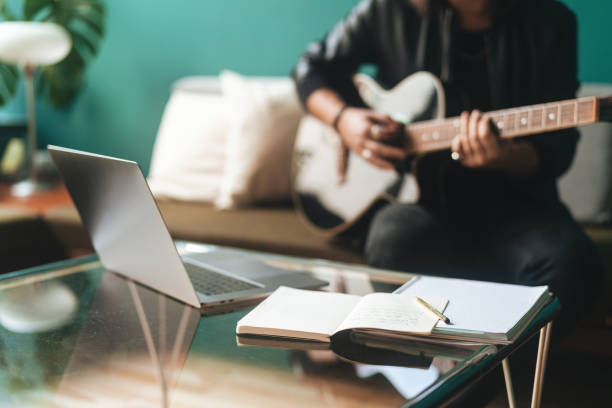 istock A guitarist playing music at home 1387236019
