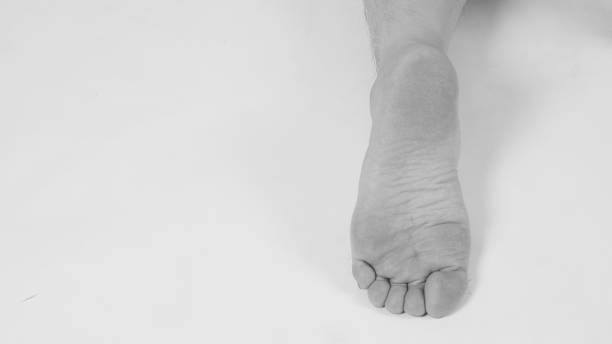 istock Man leg and barefoot on white background. 1387242051