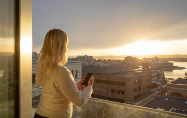 istock Woman relaxes on balcony, at sunrise 1387244451