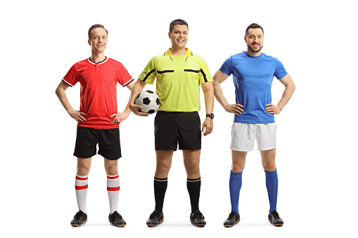 Football players from opposite teams and a referee holding a ball isolated on white background