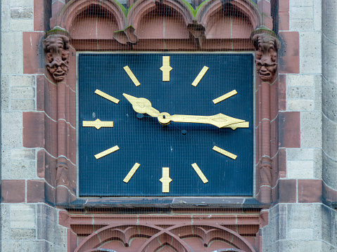 Close view of Elizabeth Tower’s ornate upper section in Gothic Revival style, showing two of four recently restored clock faces.