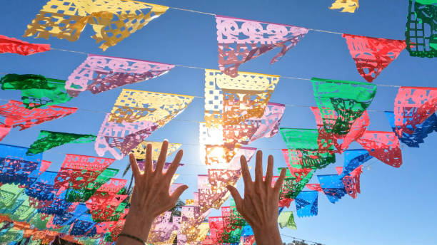 istock View of woman's hands under Papel picado 1387245555