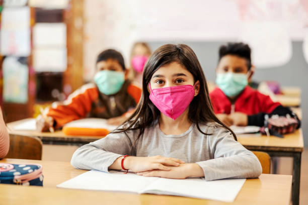 istock An Indian girl sits on class during covid 19. 1387246189
