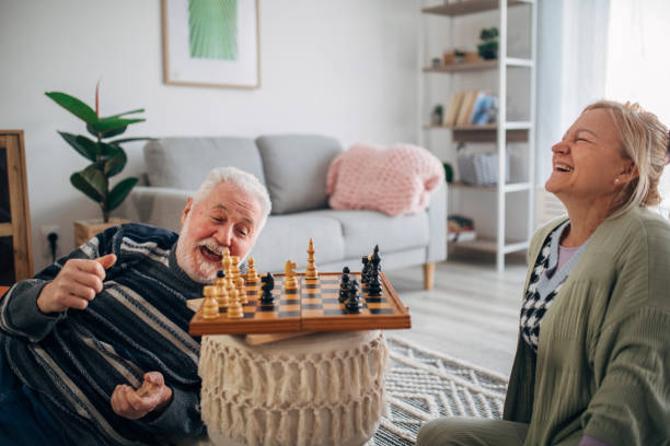 istock senior friends at home playing board games 1387246378