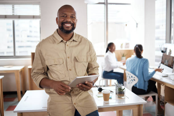 istock Shot of a mature businessman using a digital tablet in a modern office 1387247293