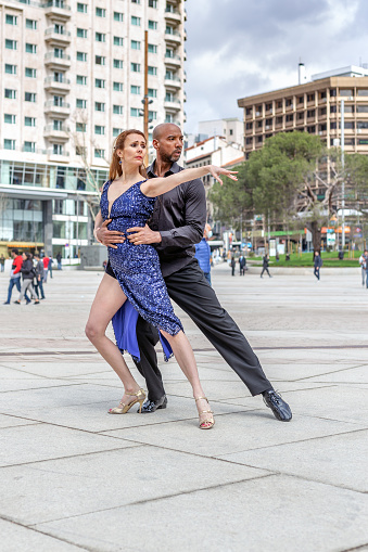 Madrid, Spain. March 9 2022. Couple of dancers dancing tango in the street