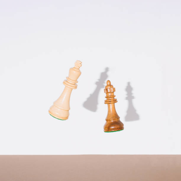 istock Chess pieces, king and queen falling down. Chess, competition or education concept. 1387247461