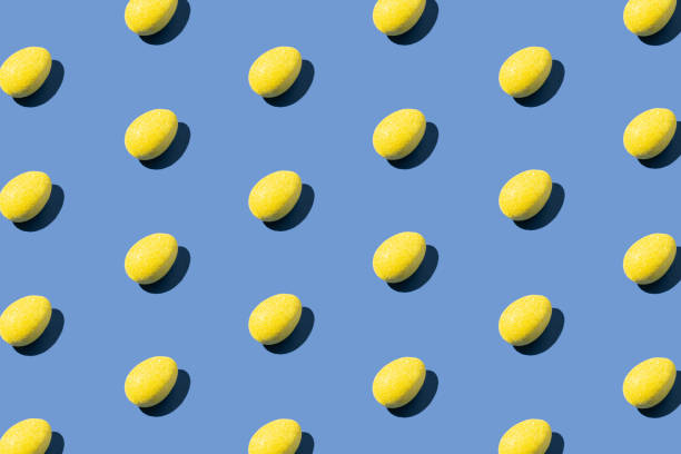 istock Pattern made of yellow eggs on blue background. Minimal Easter or food concept. 1387248400