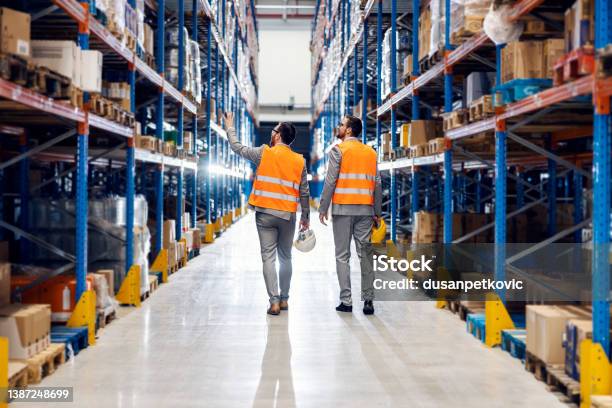 Businessman Showing Storage To His Business Partner Stock Photo - Download Image Now