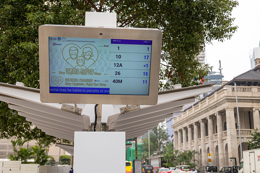 Hong Kong - March 18, 2022 : Electronic display showing the times of next buses in Central, Hong Kong. It can advise passengers of the estimated arrival time of the next bus at the bus-stops.