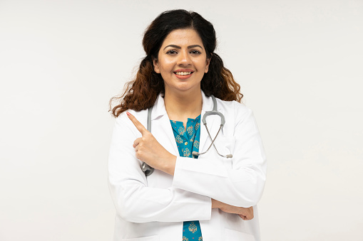 Portrait of female doctor on grey background. Healthcare and medical concept.