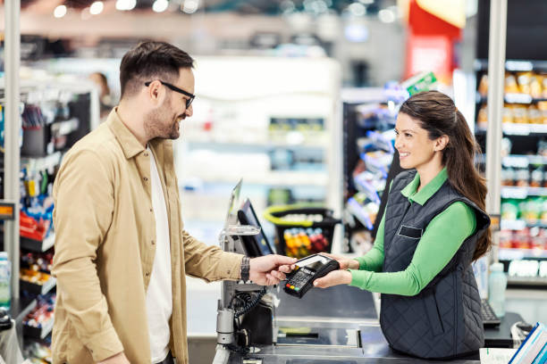 istock A customer paying at checkout in supermarket. 1387249825