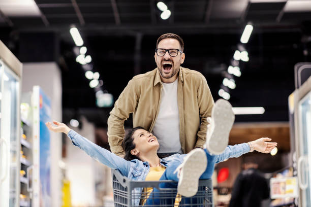 istock A happy couple having fun at supermarket. 1387249936