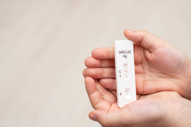 istock Child holding a negative express test for covid, space for text 1387249957