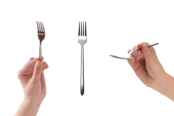 istock Fork in woman hand isolated on white. 1387249990