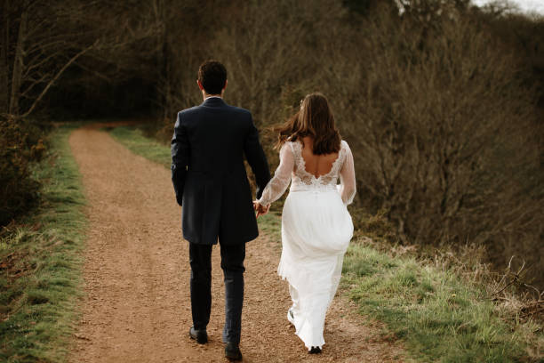 istock Rear view of a just married couple 1387251532