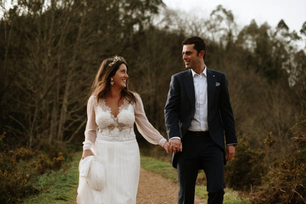 istock Just married couple walking in a forest 1387251564