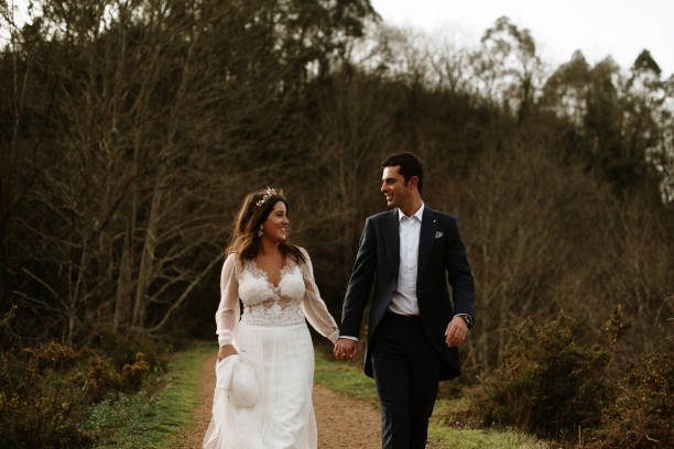 istock Just married couple walking in a forest 1387251644