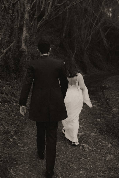 istock Rear view of a just married couple 1387251659