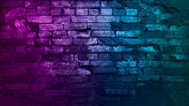 Toned purple blue green brick wall surface. neon effect. Colorful rough background with space for design.