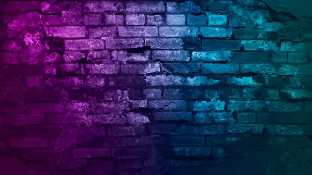 Toned purple blue green brick wall surface. neon effect. Colorful rough background with space for design. Web banner. Grunge backdrop.