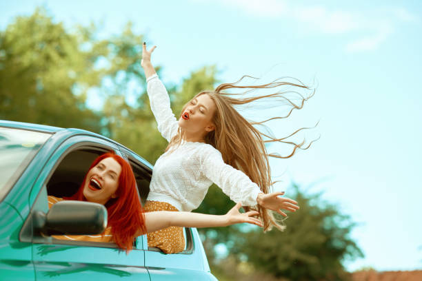 istock Girl having fun in the car 1387254833