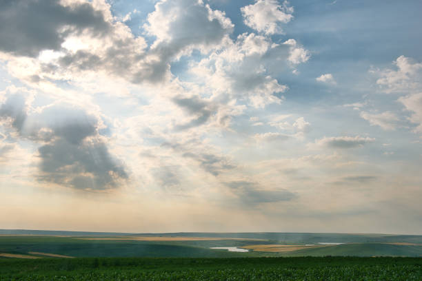 Rays of the sun breaking trough the clouds and covering the landscape in light.