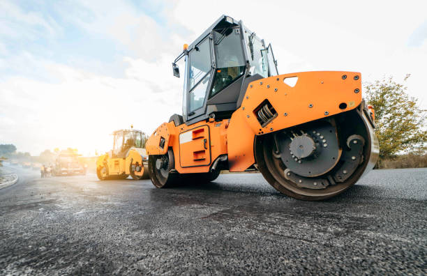 istock Vibratory asphalt roller compactor compacting new asphalt pavement. Road service repairs the highway 1387255094