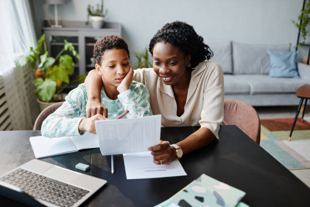 istock Smiling Mother Holding School Test Results 1387257080