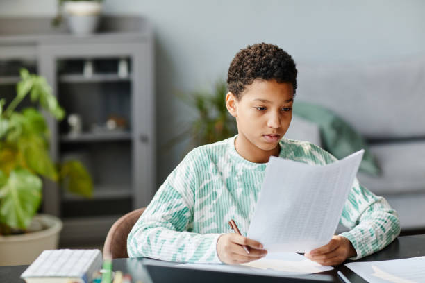 istock Young Black Girl Preparing for School Test at Home 1387257082