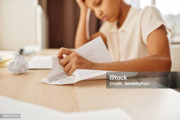 Stressed Child Crumpling Paper Stock Photo - Download Image Now - Struggle, Student, Reading